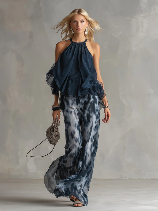 ELEGANTE IN CHIFFON CON TOP A COLLO ALTO E PANTALONI LARGHI STAMPATI